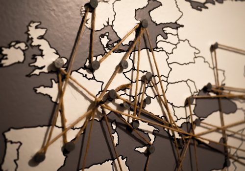 world map with pins and strings